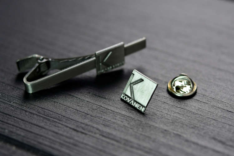 Die struck lapel pin and tie bar